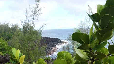 beautiful deep blue ocean crashes onto the rocky shore of the big island hawaii