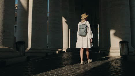 Woman walking between columns