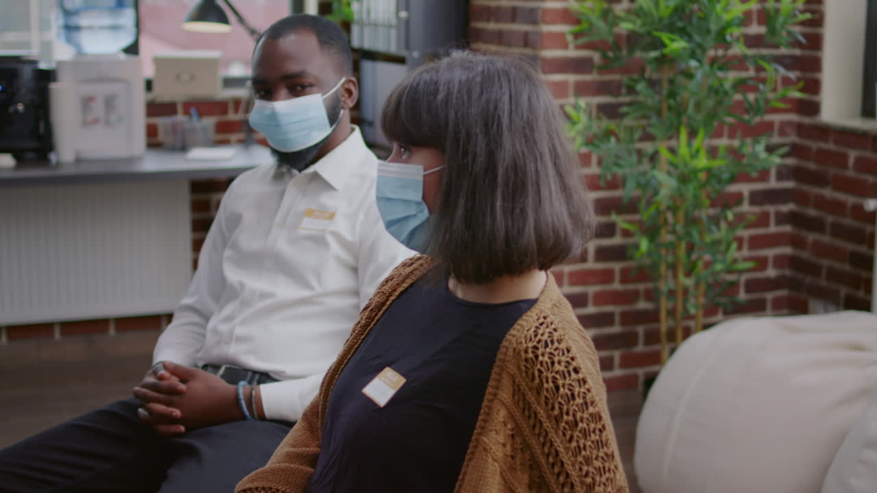 Woman talking about alcohol addiction problems with group of people at aa meeting