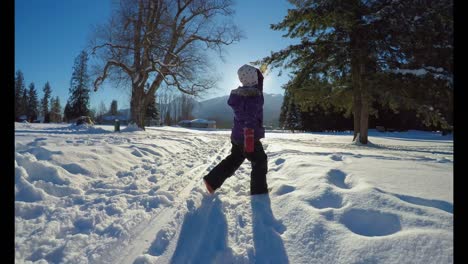 kid playing in the snow during winter 4k