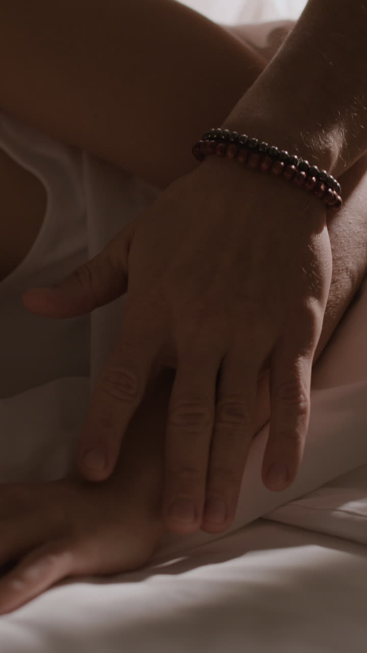 Close-up of hands and body parts demonstrating tender touch