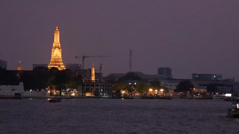 wat arun glowing by the chao phraya river