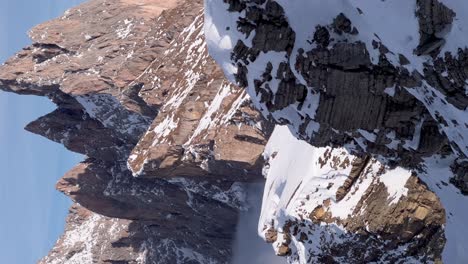 A-vertical-upward-pan-reveals-the-snow-capped-mountain-peaks-of-Seceda-Dolomites-in-Ortisei-during-winter