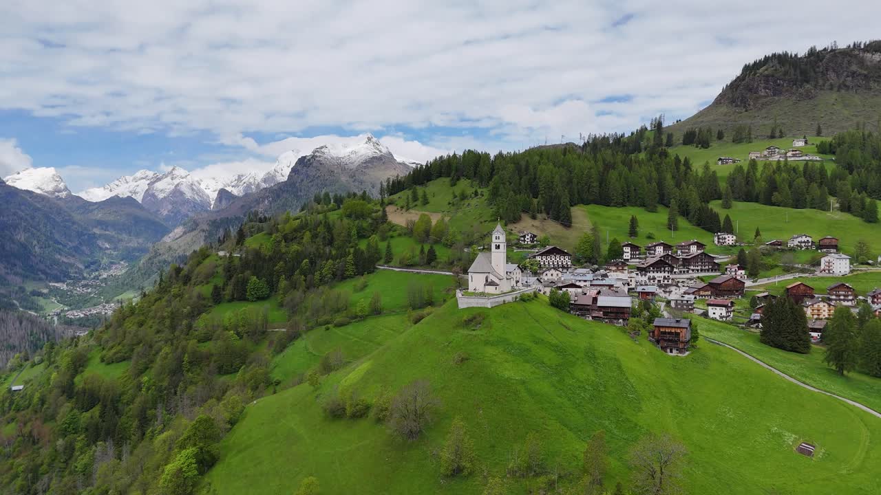 Aerial view of Selva di Cadore village and church filmed with drone