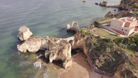 aerial view of pont romain de lagos, rock arch bridge at praia dos estudantes algarve, portugal