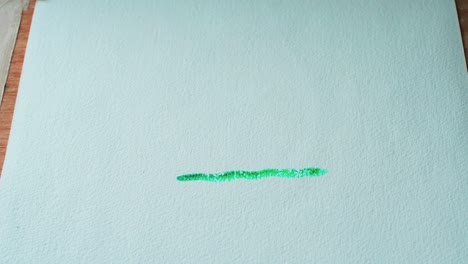 painting a green line with watercolors on paper