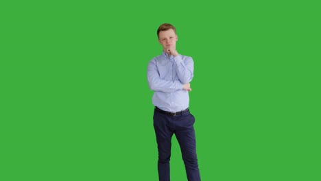 young caucasian man standing against green screen background. male person isolated on chroma key. casual business professional portrait