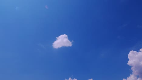 timelapse: sun beams shining through moving dramatic white clouds