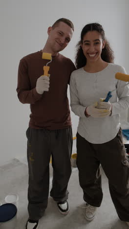 happy couple painting their new home together
