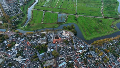 the drone is flying over the edge of the city centre and the meadow of den bosch the netherlands aerial footage 4k