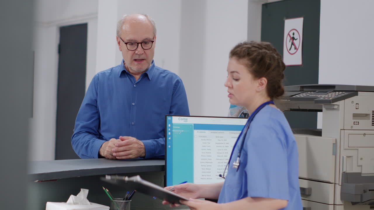 Healthcare professionals discussing medical records at hospital reception