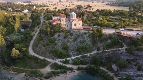 serbian orthodox church of the ascension of the lord, drone shot revealing popular cetina river spring izvor cetine in omis, croatia