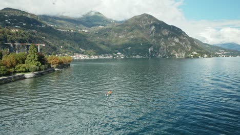 AERIAL:-Motor-Boat-Sails-near-Coast-of-Menaggio