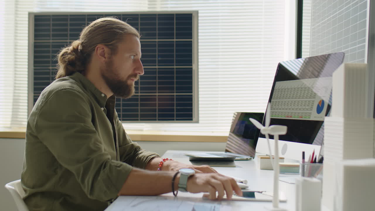 Renewable Energy Developer Using Digital Tablet during Workday