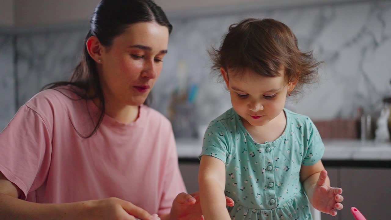 A Heartwarming Moment Between Mother and Child: Joyful Playtime and Shared Laughter in a Bright Kitchen Filled with Creativity and Warmth