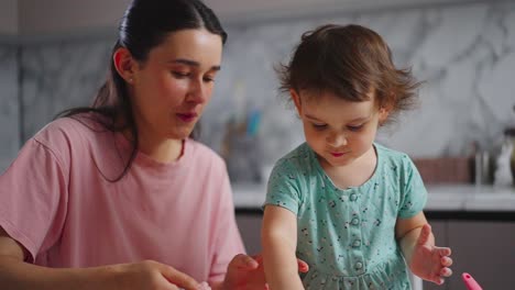 A Heartwarming Moment Between Mother and Child: Joyful Playtime and Shared Laughter in a Bright Kitchen Filled with Creativity and Warmth