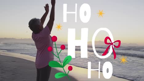 animation of christmas greetings text over biracial senior woman on beach