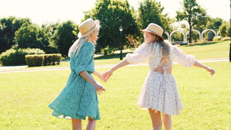 two young women enjoying a sunny day in the park