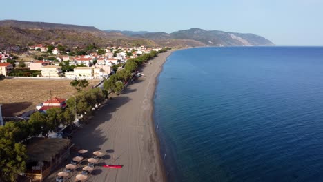 Drone view of Greek Island longest Vatera Beach tavernas, hotels, and restaurants surrounded by mountains and sea, Lesvos Island