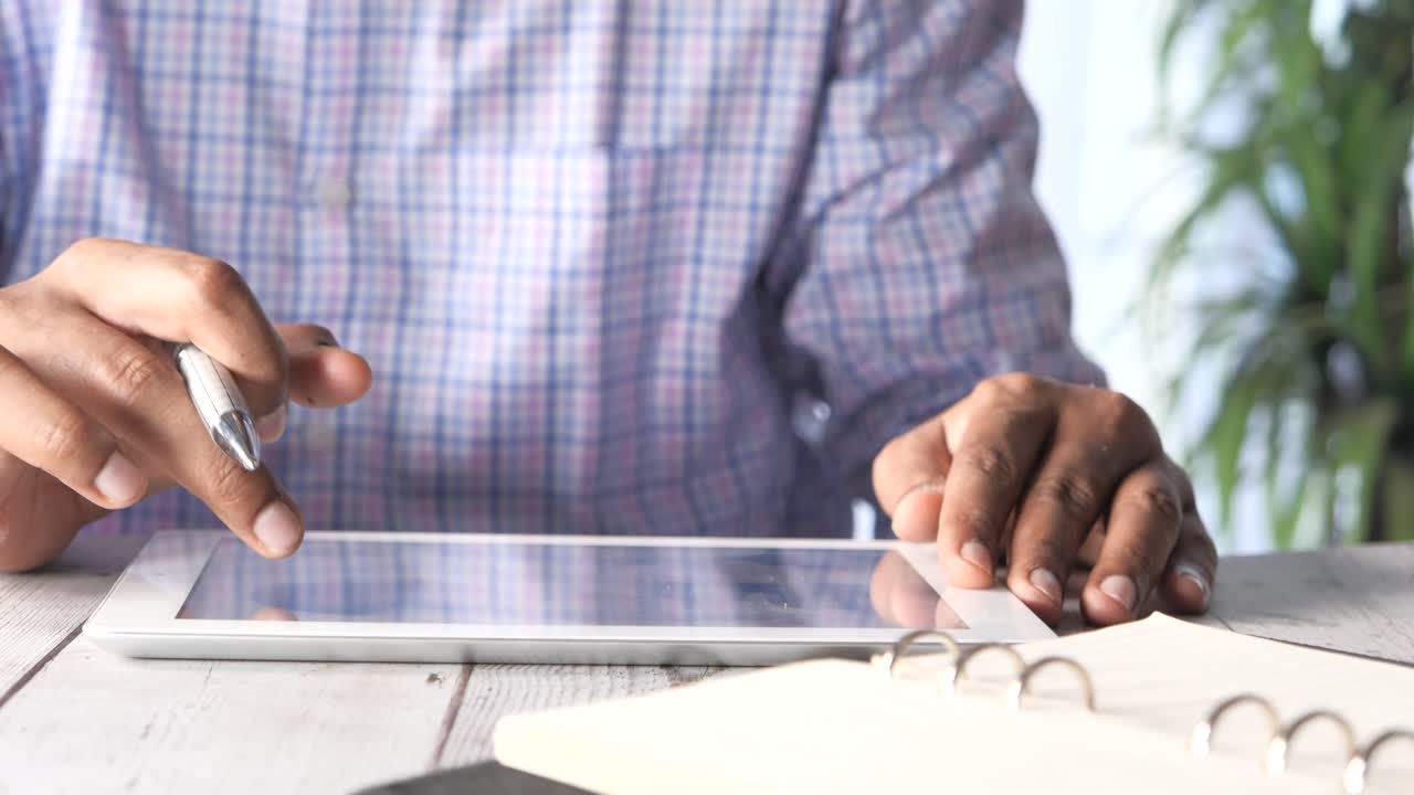 Person working on a tablet in an office setting