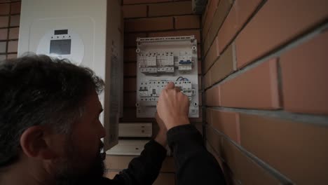 an electrician installing an inverter in a home. the image shows technical skill, modern tools, and attention to safety in electrical work