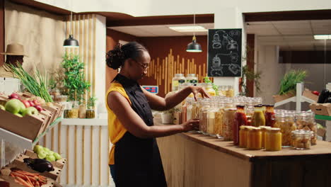 African-american-vendor-arranging-bulk-products-at-local-store