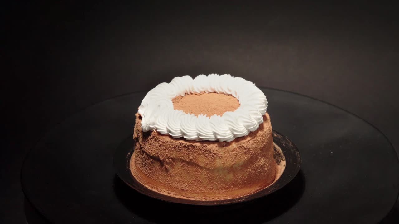 mini petite Cinnamon cake with creme in a turn table sweet tasty healthy black background loop personal slice portion