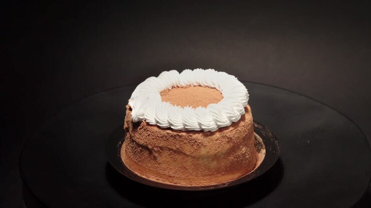 mini petite Cinnamon cake with creme in a turn table sweet tasty healthy black background loop personal slice portion