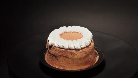 mini petite cinnamon cake with creme in a turn table sweet tasty healthy black background loop personal slice portion