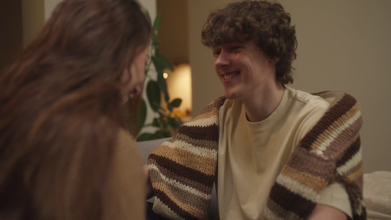 A smiling man with curly hair