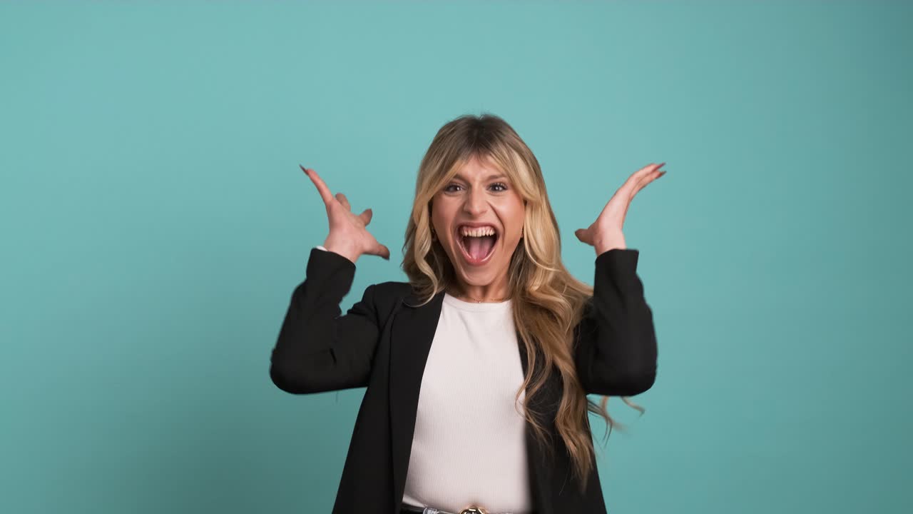 Amazed transgender businesswoman screaming as she celebrates success