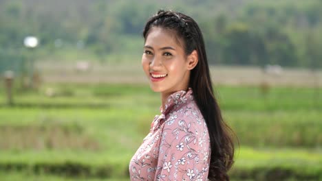 smiling asian woman in a floral dress