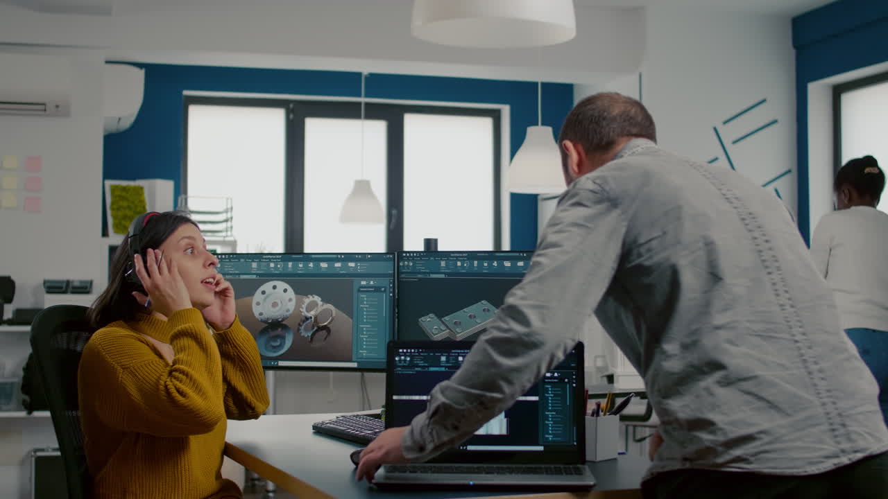 Teamwork sharing ideas about industrial project analysing 3D gears