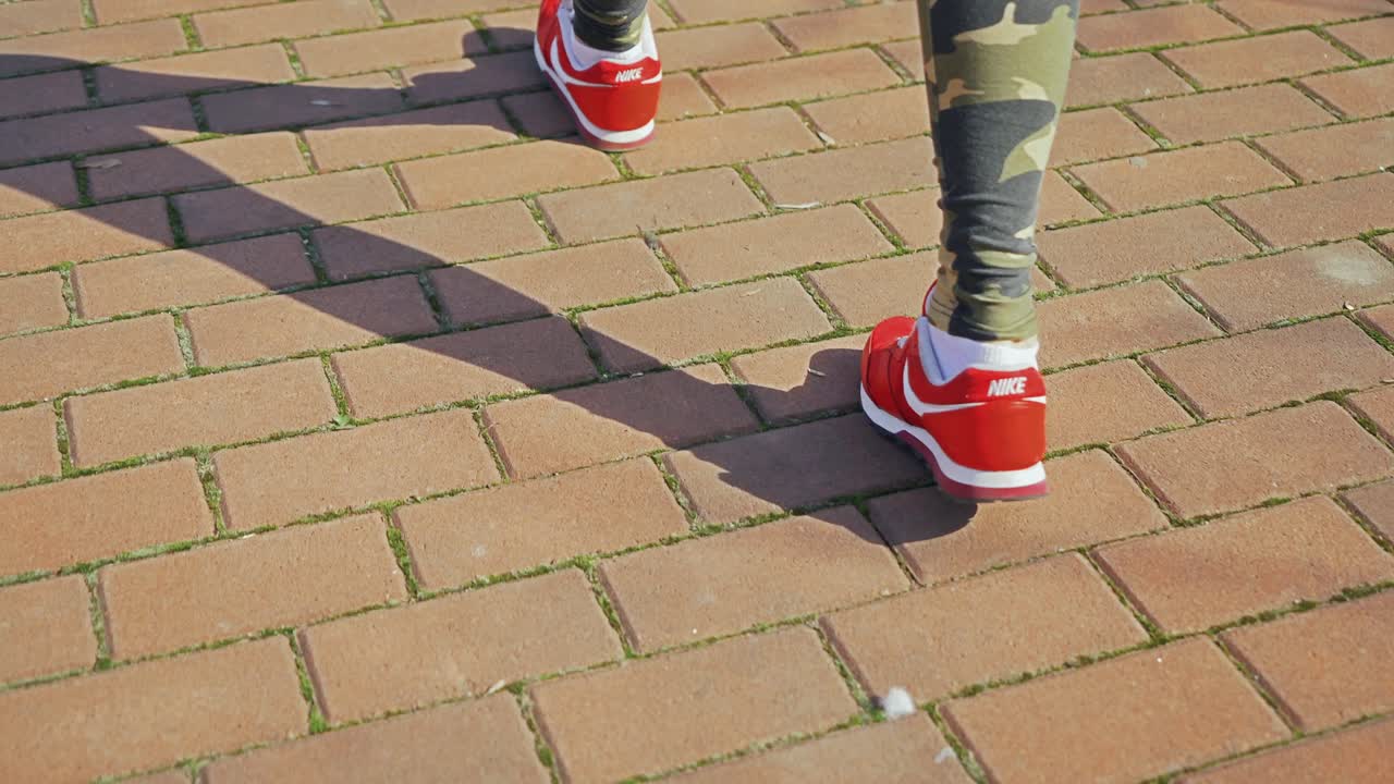 woman with an athletic pair of legs going for a jog or run on running race track