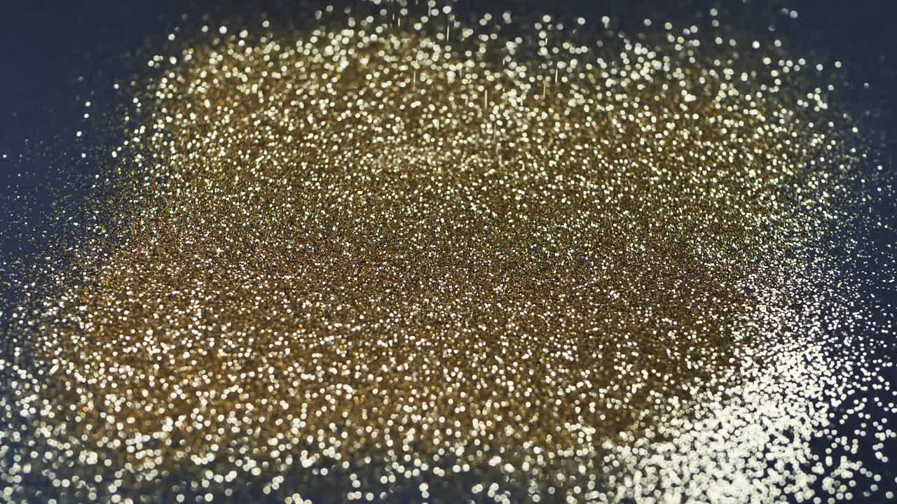 Gold dust falls on a black background