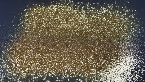 el polvo de oro cae sobre un fondo negro