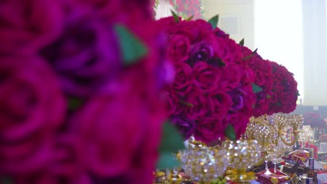 Revealing-the-wedding-table-full-of-drinks-and-food-out-of-the-boquete-of-roses-placed-throughout-the-table-magical-view-experience-heavenly-atmosphere-Roma-gypsy-wedding-Czech-Slovakian-cinematic