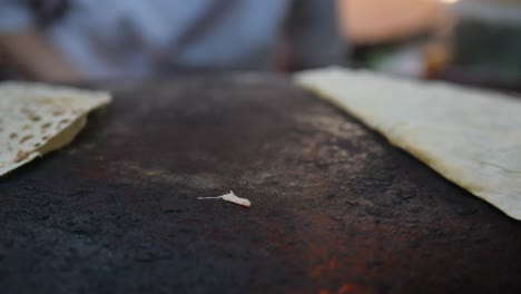 preparing flatbread on a tandoor