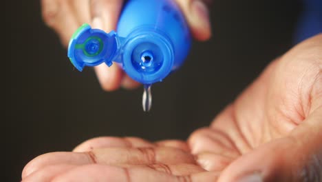 person applying oil to hand