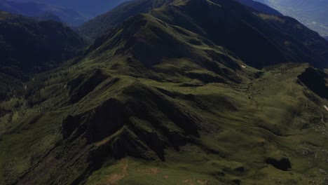 Drone-shot-tilting-up-to-reveal-amazing-landscape-in-Lagorai,-Italy,-with-colorful-sky-and-green-peaks-bellow