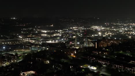 wide sinking aerial of residential area in sheffield, uk, at night