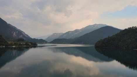 Grandiose-mountain-land-watches-carefully-about-peaceful-and-fascinating-pretty-lake-ledro