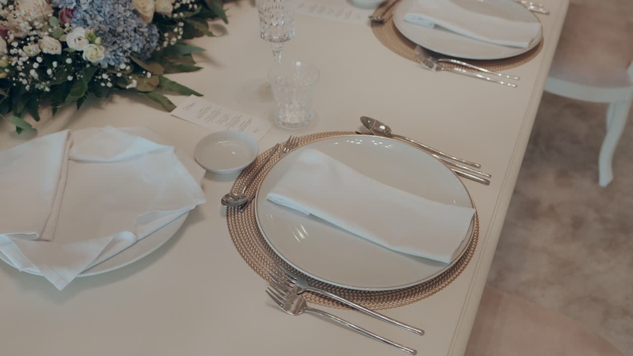 Elegant wedding table arrangement with plates and napkins