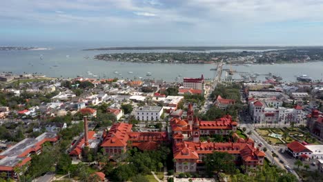 4k-Aerial-forward-slider-shot-over-Flagler-College-in-Downtown-St-Augustine,-flying-towards-the-Bridge-of-Lions