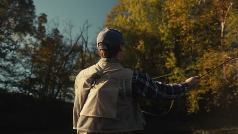 man fly fishing in autumn