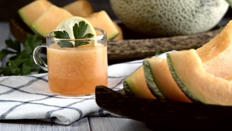 whole and sliced of japanese melons,honey melon or cantaloupe (cucumis melo) glass of melon smoothie healthcare concept.