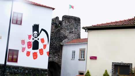 portuguese flag over vinhais castle ruins, braganza, portugal