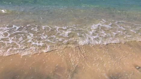 turquoise sea water waves on sand by the shore on the island of gili trawangan, bali, lombok, indonesia