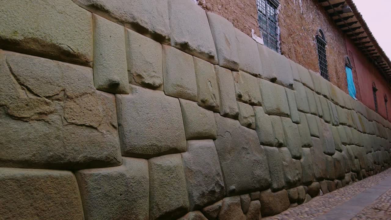 Historic Inca stone wall with the famous Twelve-Angled Stone along Hatunrumiyoc Street in Cusco, Peru. Close-up view