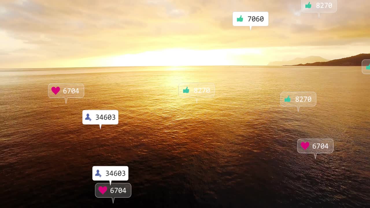 Animation of social media icons floating over ocean during sunset